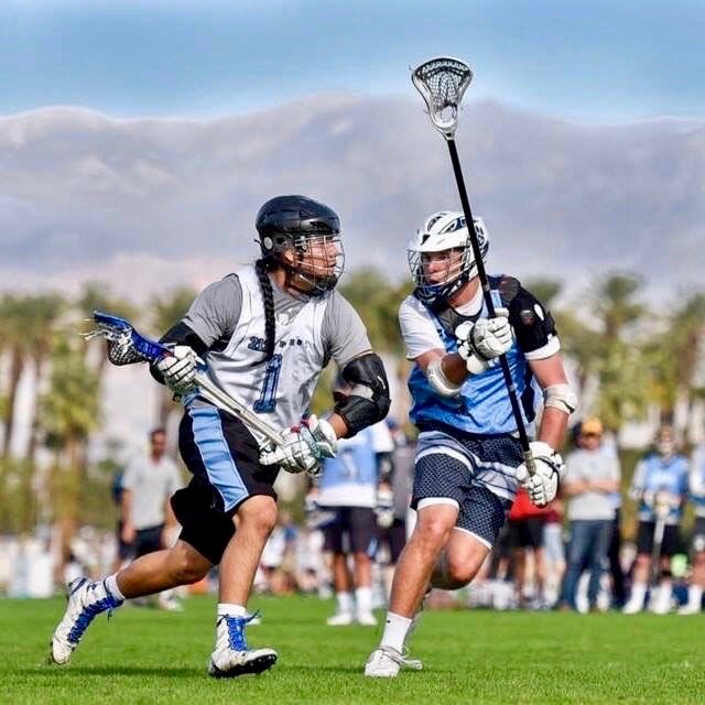 NLL pro Tehoka Nanticoke playing on the field with mountains in the background