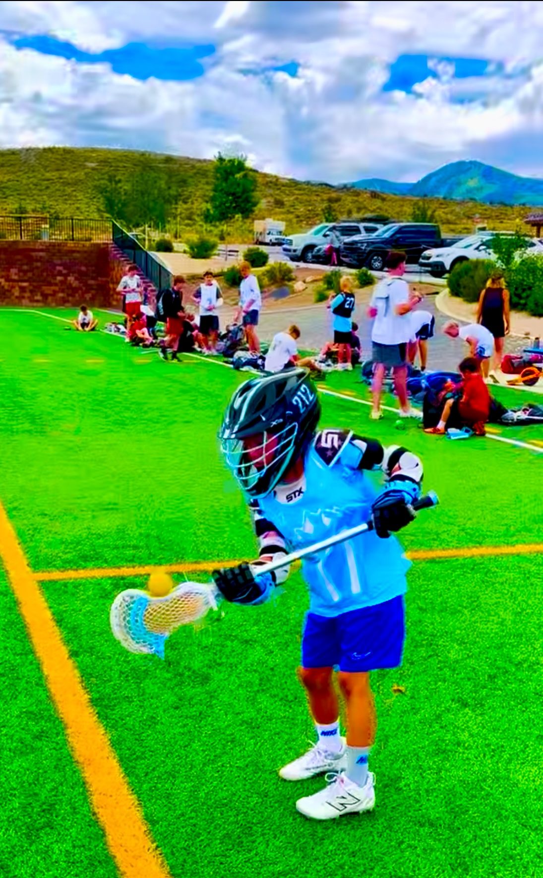 212 Lacrosse player shooting during warmups on a turf field